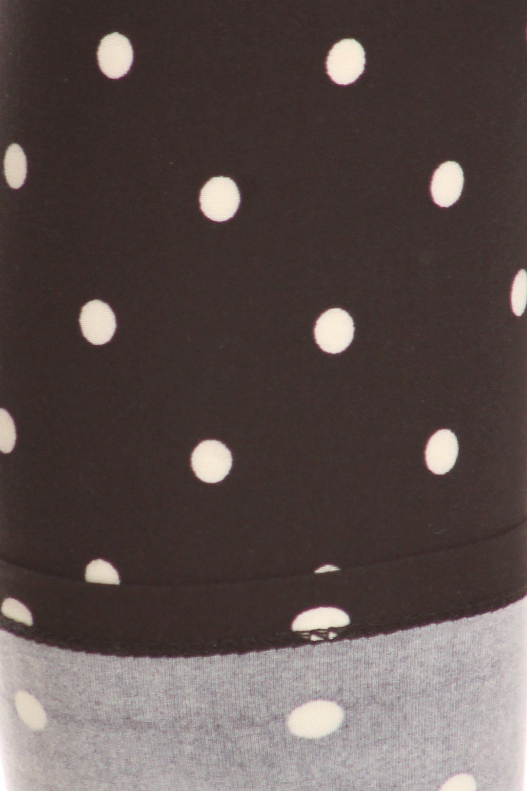 High Waisted Leggings With An Elastic Band In A White Polka Dot Print Over A Black Background